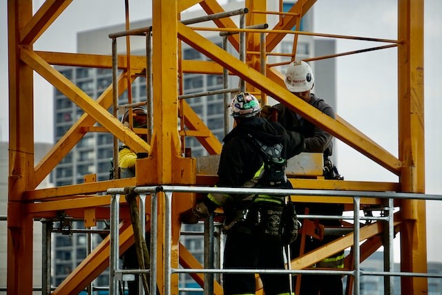 Worker on a yellow high rise machine